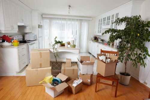 Packed moving boxes and furniture ready for transport in Cudham
