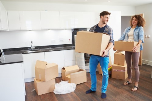 Professional movers carrying furniture during a local relocation in Cudham