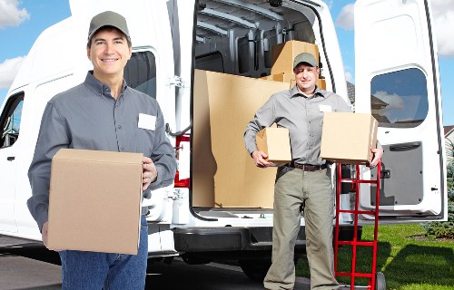 Office moving team setting up workspaces after relocation